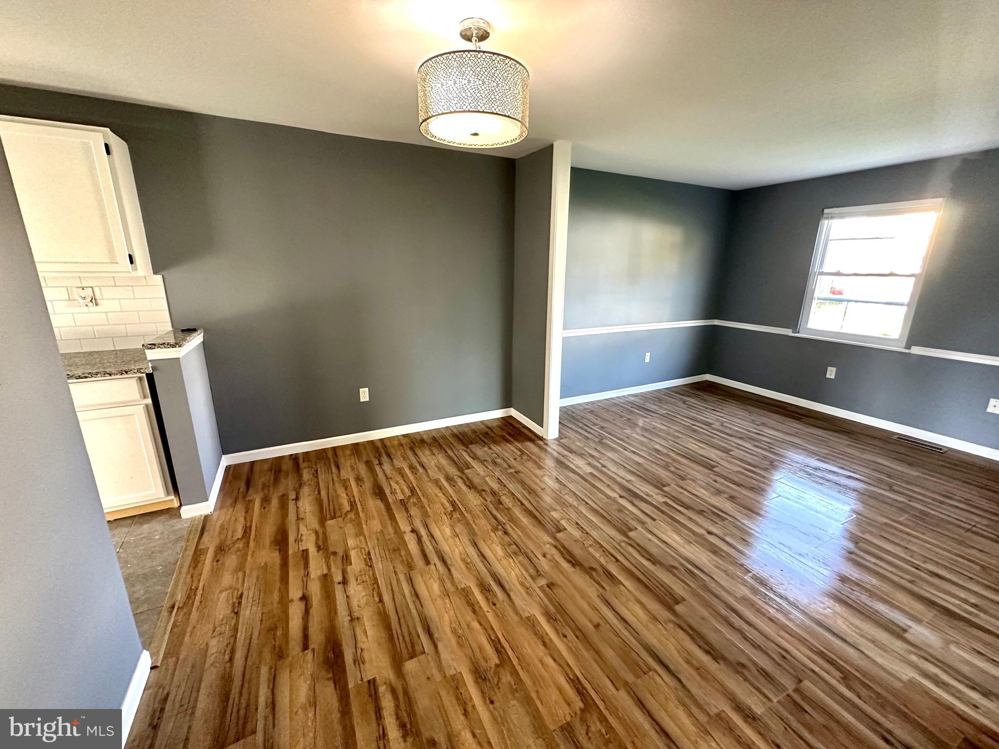 326 Brandon Drive Bear, DE 19701 - Photo 10 of 16 a view of a room with wooden floor and staircase