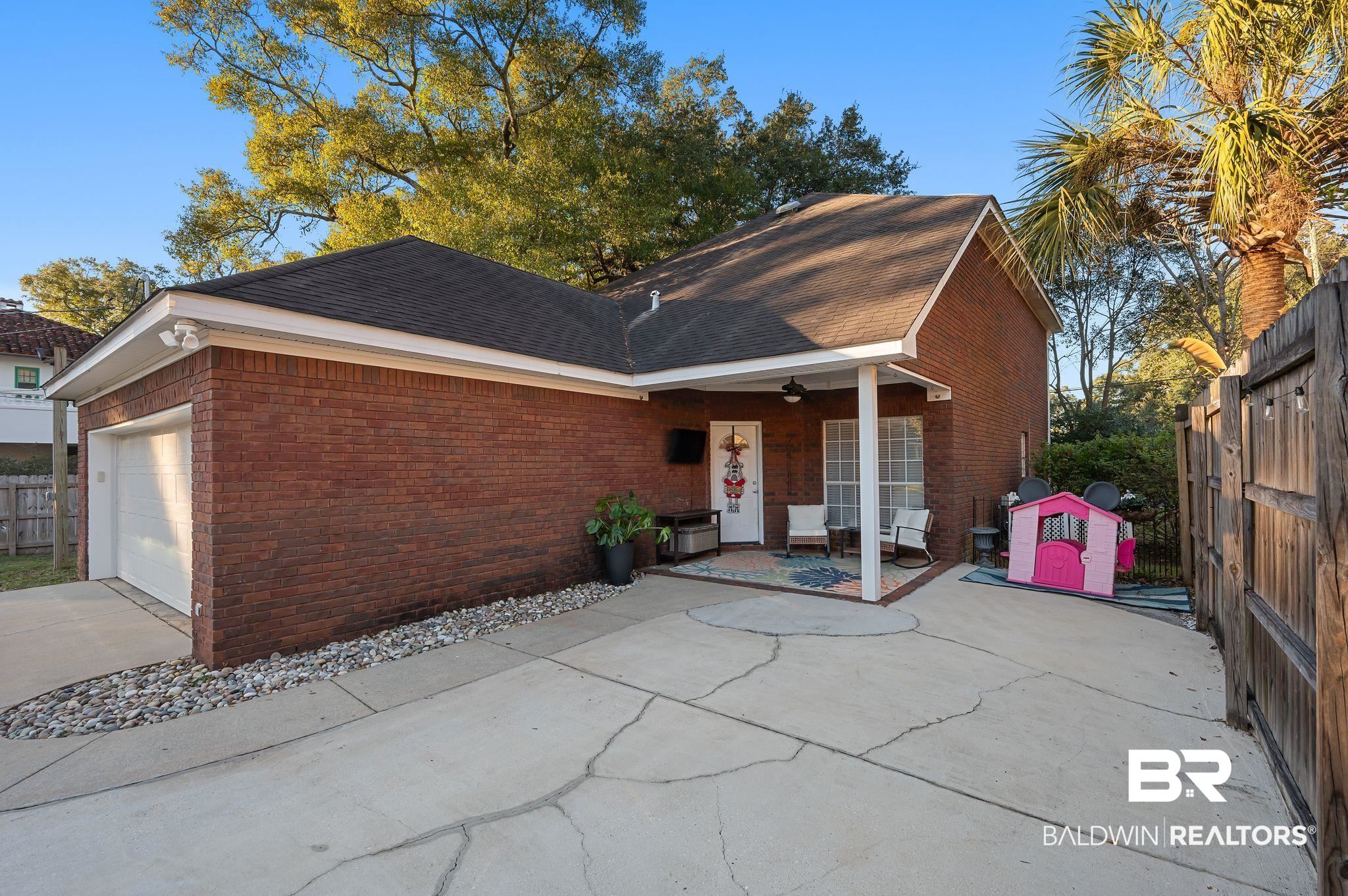 1825 Spring Hill Avenue Mobile, AL 36607 - Photo 34 of 43 View of front of property featuring brick siding, roof with shingles, and driveway