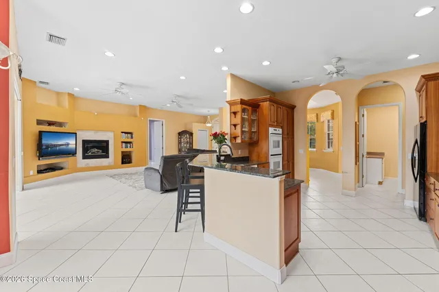 a kitchen with stainless steel appliances granite countertop a sink and a refrigerator