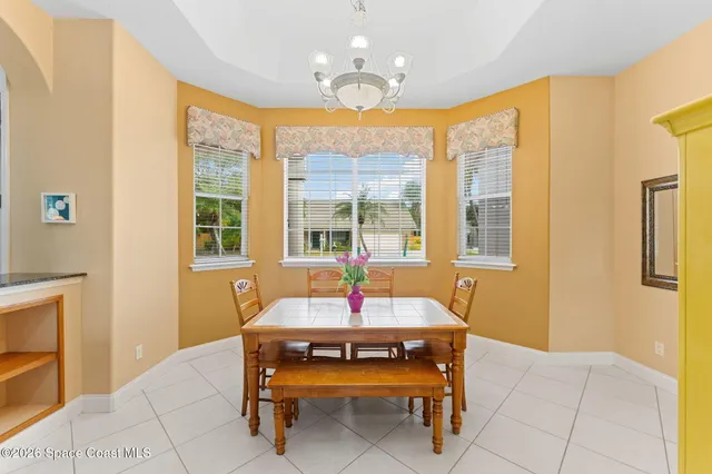 a outdoor dining room with furniture and a chandelier