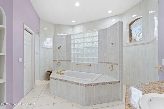 a bathroom with a tub and shower