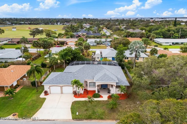 an aerial view of residential houses with outdoor space