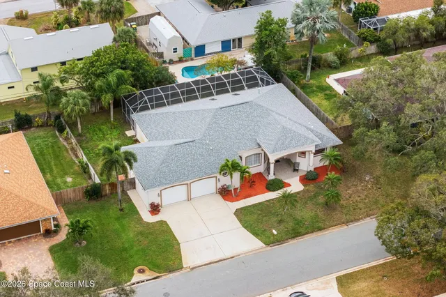 an aerial view of residential houses with outdoor space