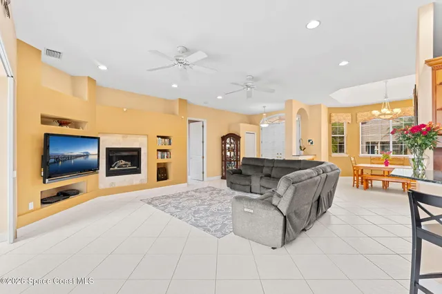 a living room with furniture and kitchen view