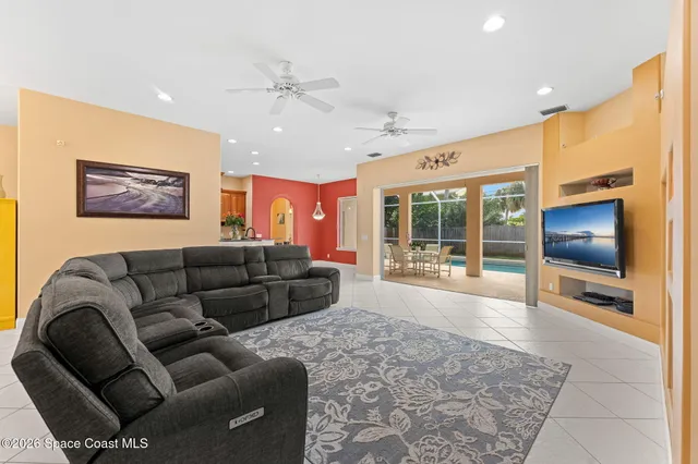 a living room with furniture window and a flat screen tv