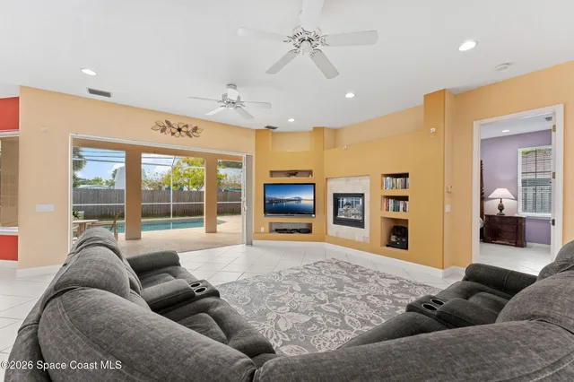a view of a dining room with furniture and a chandelier