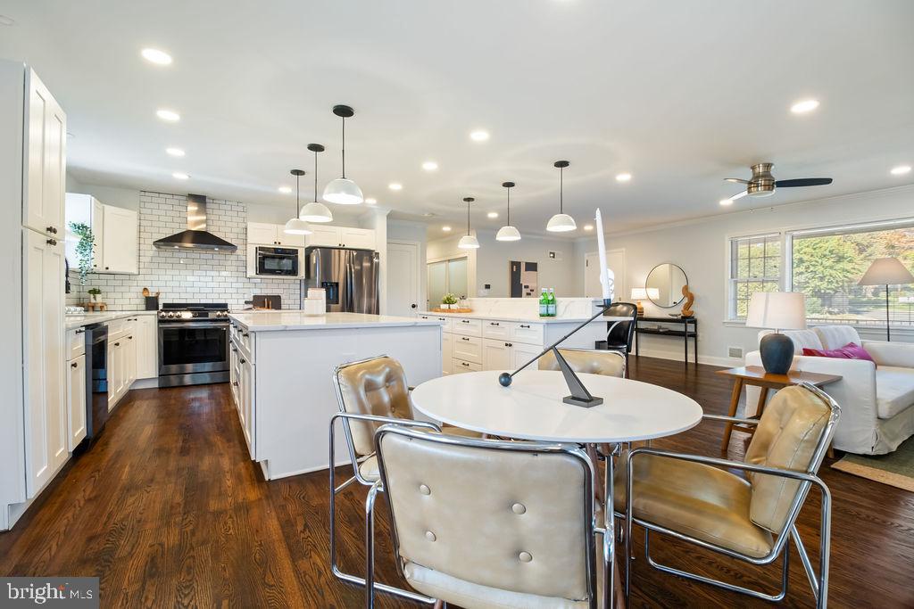 3100 North Glebe Road Arlington, VA 22207 - Photo 12 of 101 a open kitchen with kitchen island a stove a table and chairs in it
