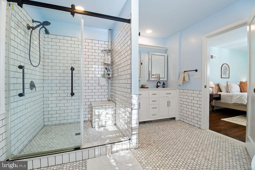 3100 North Glebe Road Arlington, VA 22207 - Photo 25 of 101 a bathroom with a double vanity sink a mirror and shower
