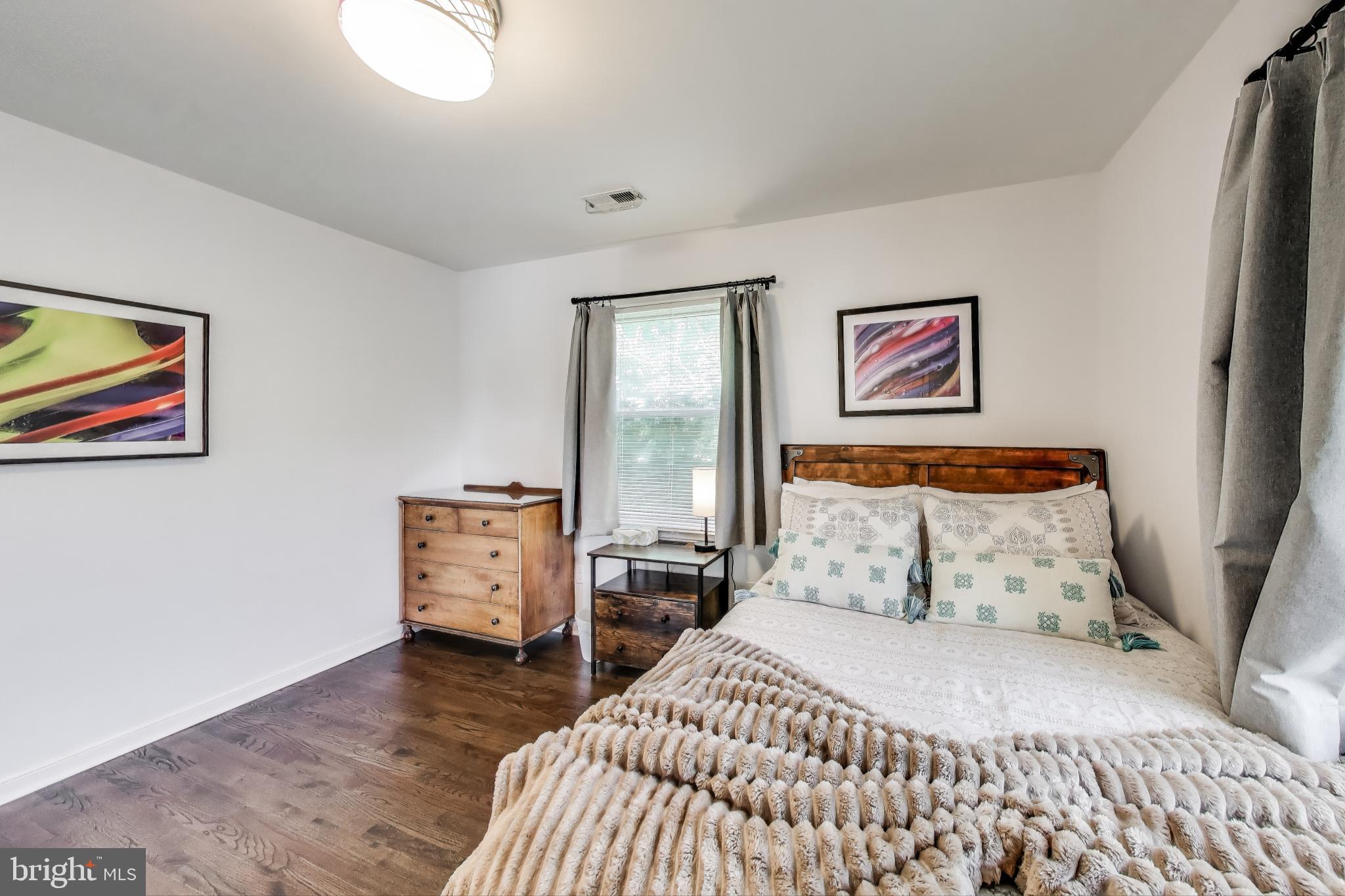 3100 North Glebe Road Arlington, VA 22207 - Photo 74 of 101 a bedroom with a bed and wooden floor