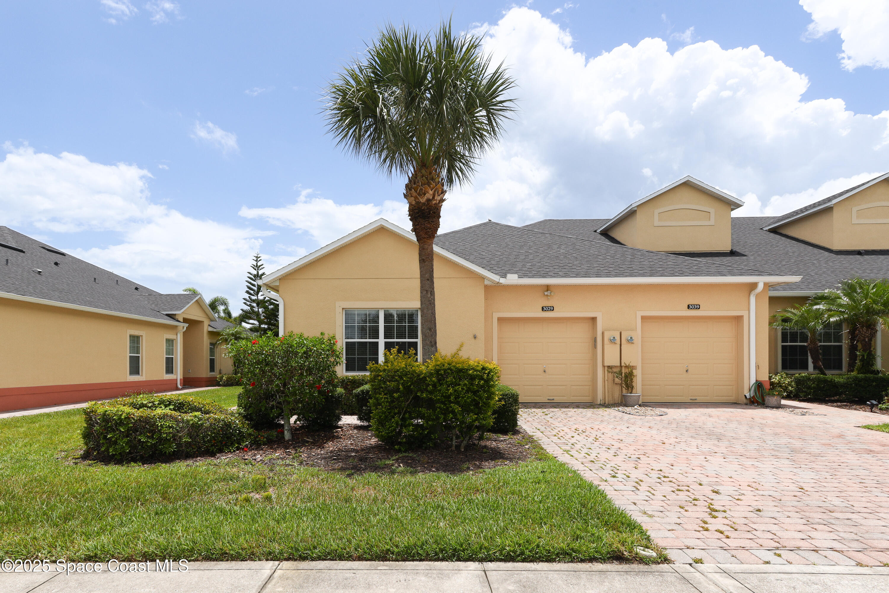 3029 Vallejo Way Melbourne, FL 32940 - Photo 1 of 26 a front view of a house with a yard and garage
