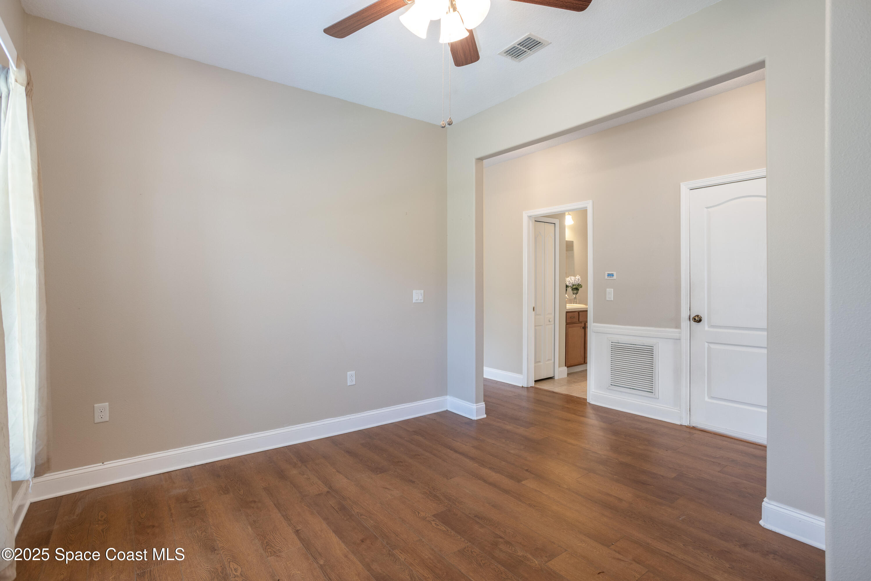 3029 Vallejo Way Melbourne, FL 32940 - Photo 12 of 26 a view of an empty room with wooden floor