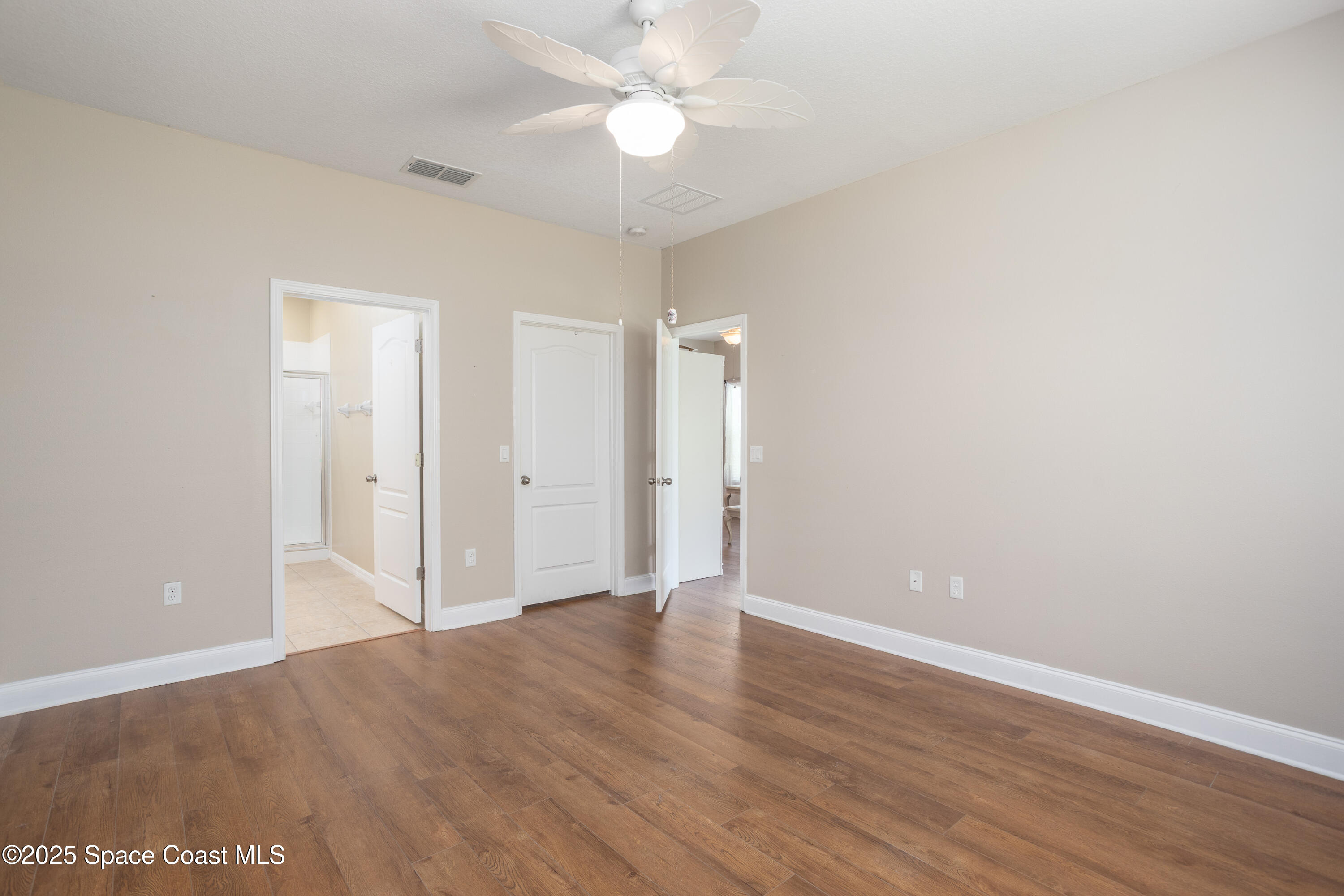 3029 Vallejo Way Melbourne, FL 32940 - Photo 14 of 26 a view of an empty room with wooden floor