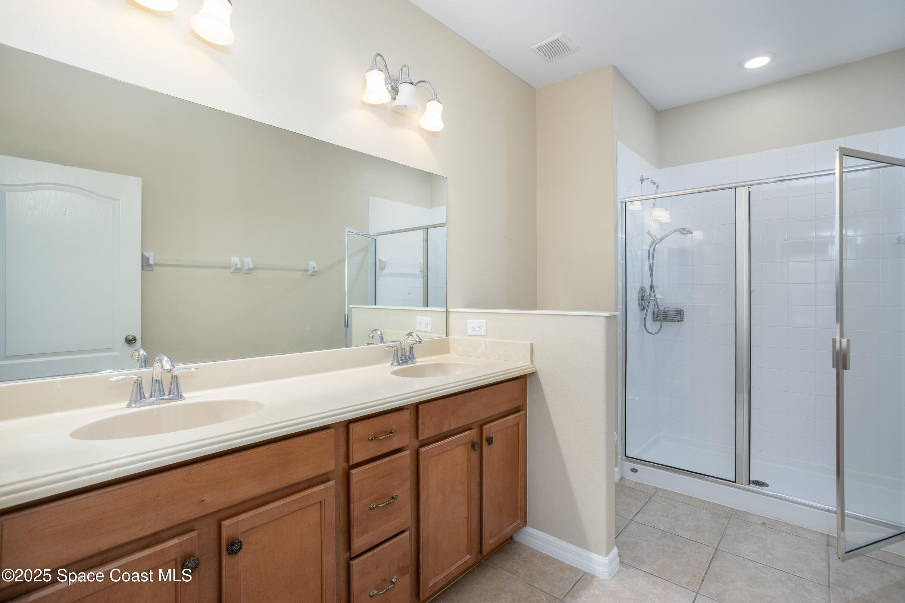 3029 Vallejo Way Melbourne, FL 32940 - Photo 16 of 26 a bathroom with a sink double vanity and a mirror
