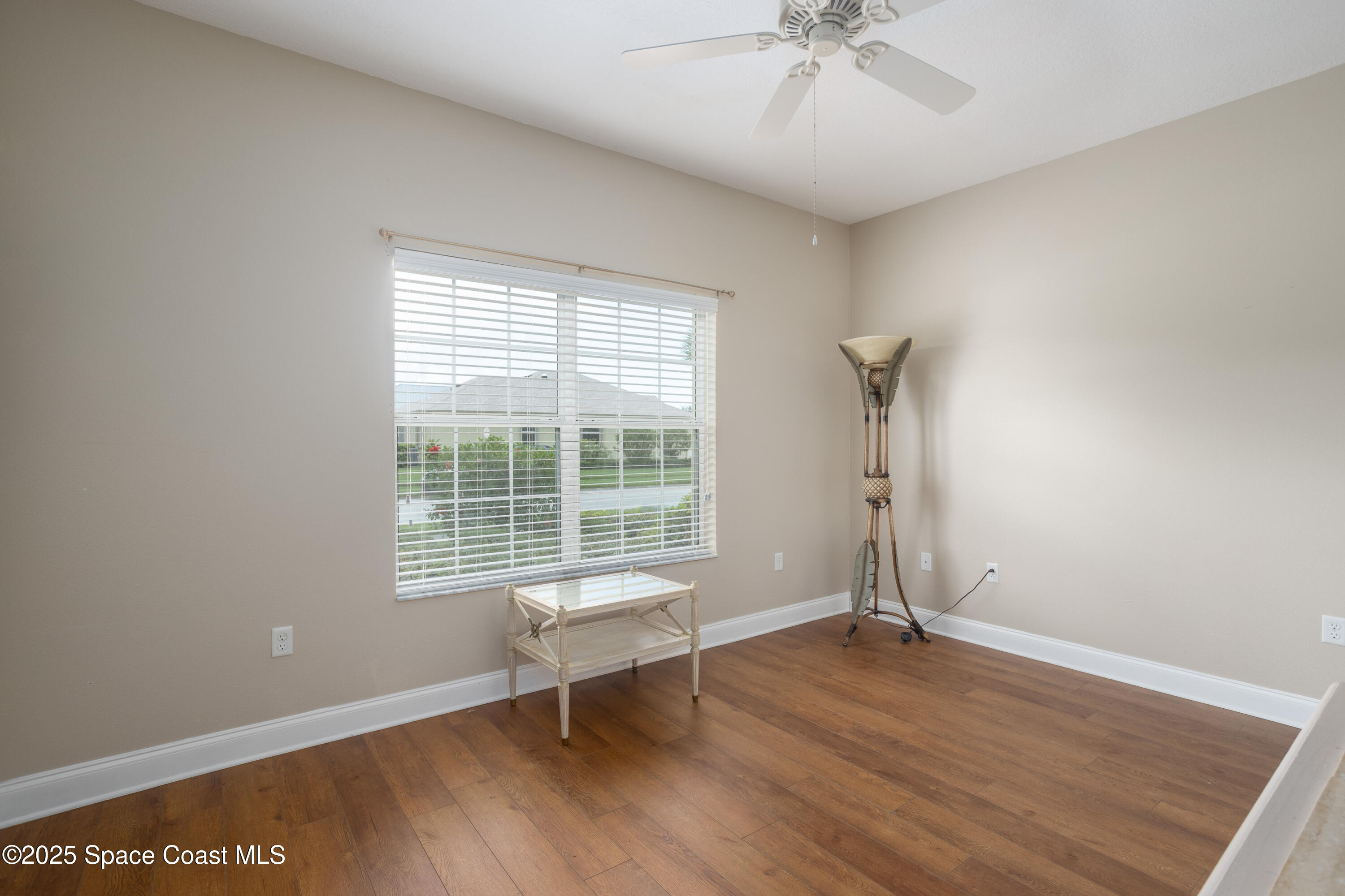 3029 Vallejo Way Melbourne, FL 32940 - Photo 18 of 26 an empty room with wooden floor and windows