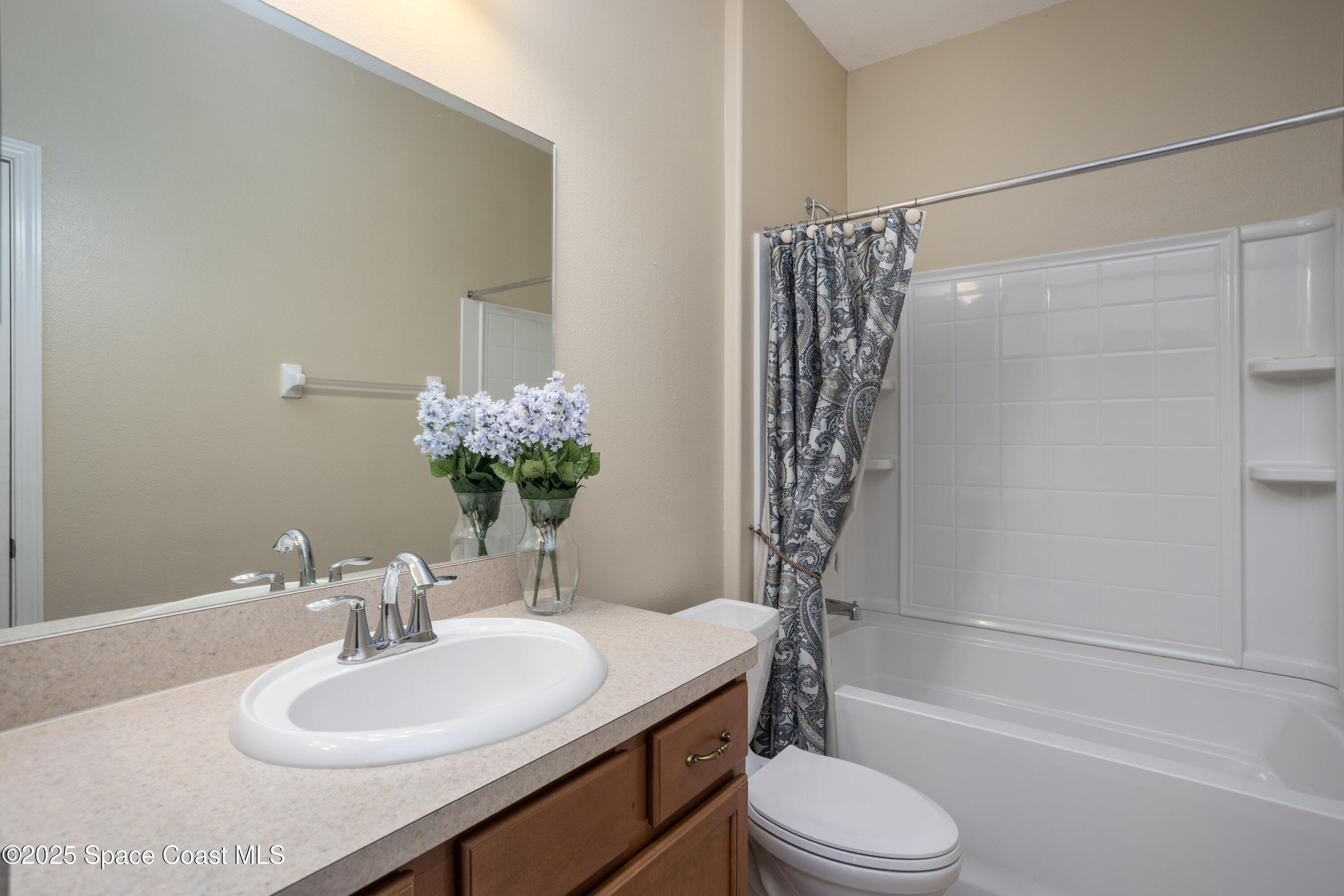 3029 Vallejo Way Melbourne, FL 32940 - Photo 20 of 26 a bathroom with a sink toilet and shower