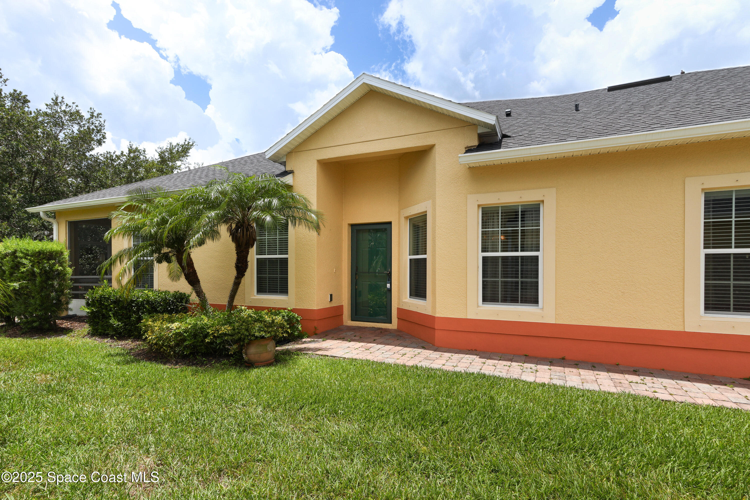 3029 Vallejo Way Melbourne, FL 32940 - Photo 2 of 26 a front view of a house with a garden