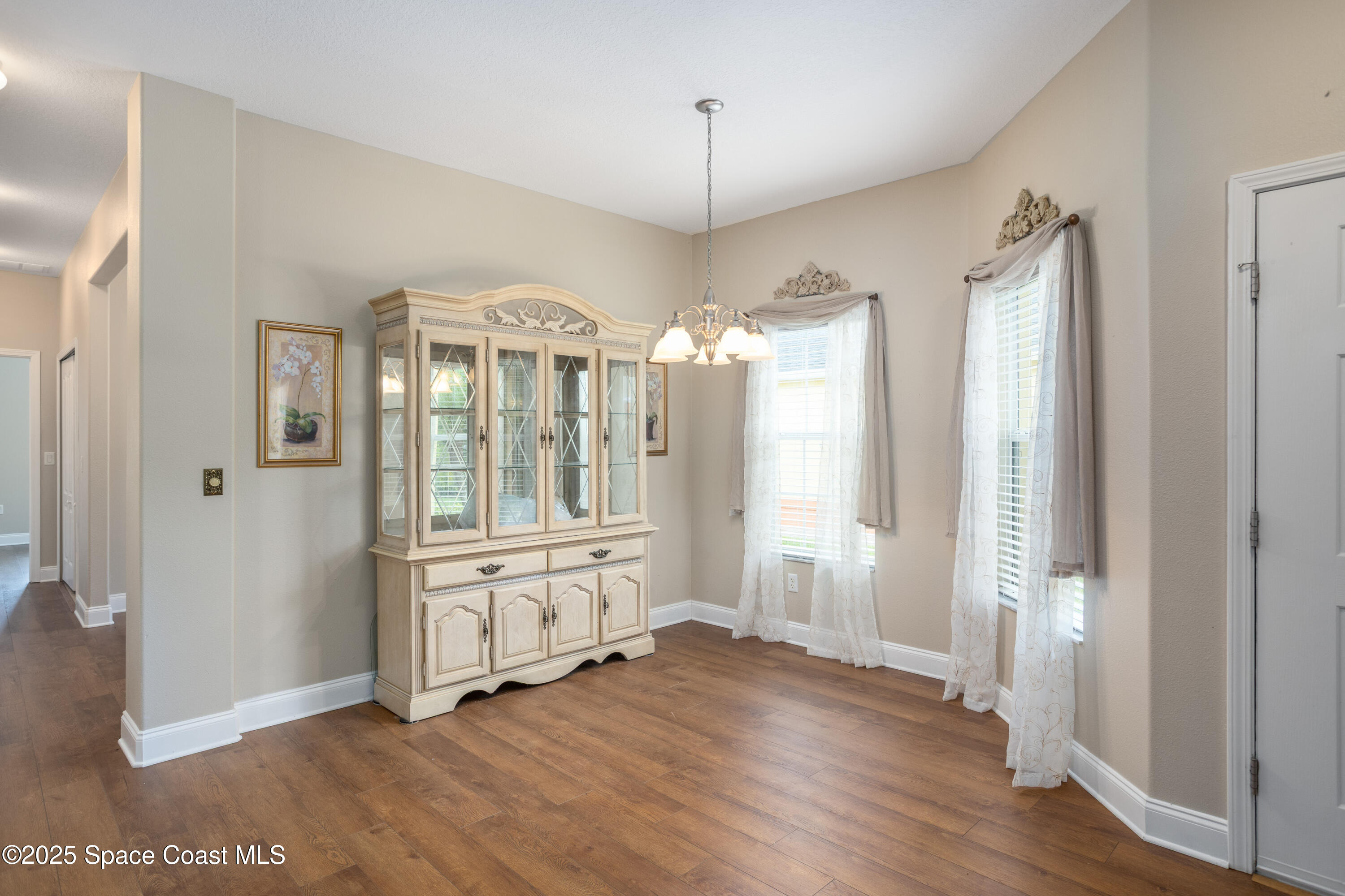 3029 Vallejo Way Melbourne, FL 32940 - Photo 6 of 26 a view of a hallway with wooden floor and a living room