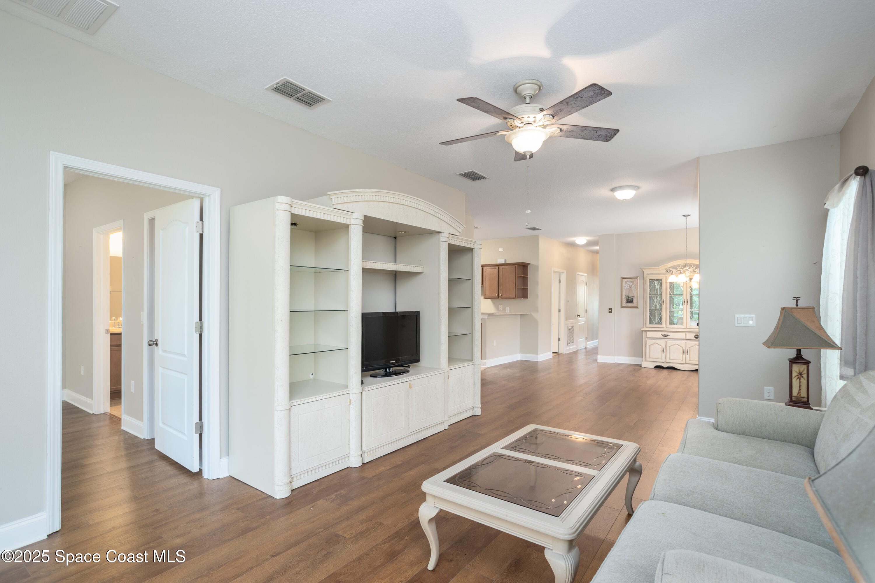 3029 Vallejo Way Melbourne, FL 32940 - Photo 8 of 26 a living room with furniture and a view of kitchen