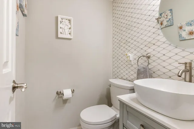 a white toilet sitting next to a white sink
