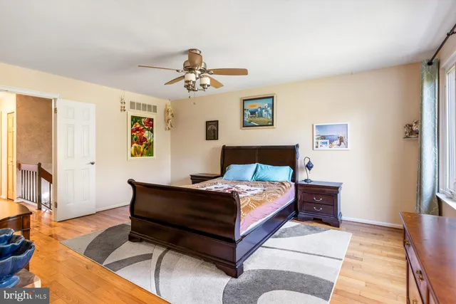 a bedroom with a bed lamp and a dresser