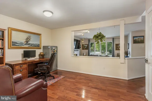 a view of a workspace with furniture and a window