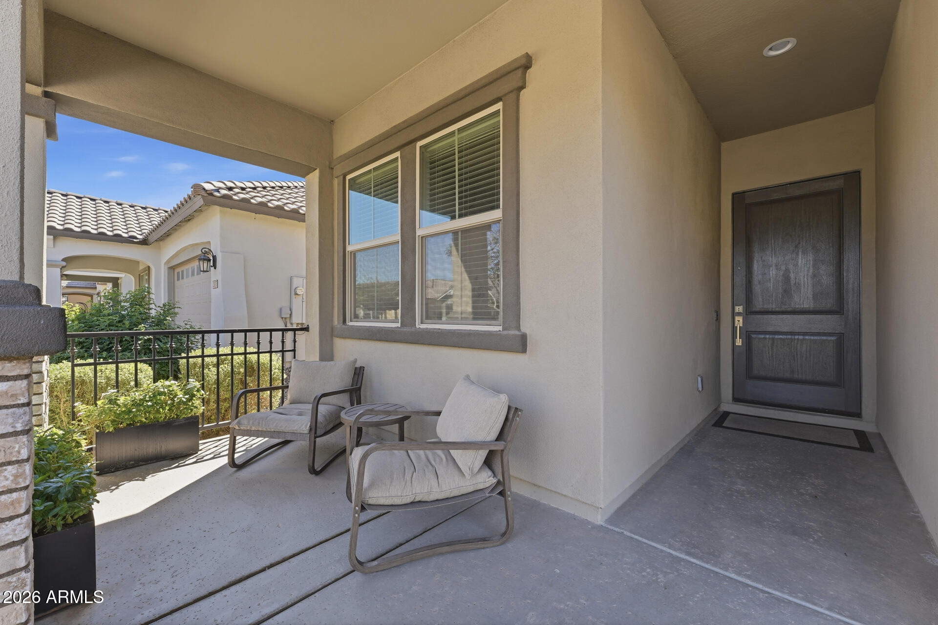 23069 East Mayberry Road Queen Creek, AZ 85142 - Photo 3 of 48 a balcony with furniture and a potted plant