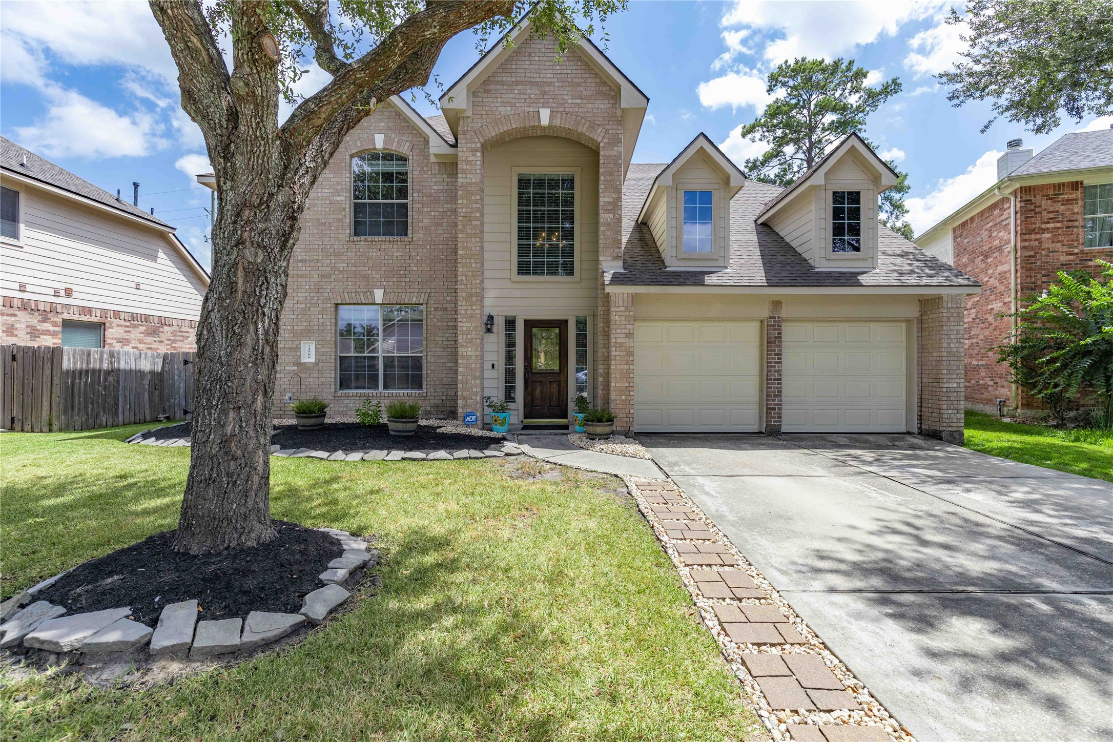24506 Fort Path Drive Spring, TX 77373 - Photo 1 of 46 Charming two-story home with a welcoming facade, featuring large arched windows and a spacious driveway leading to a double garage.