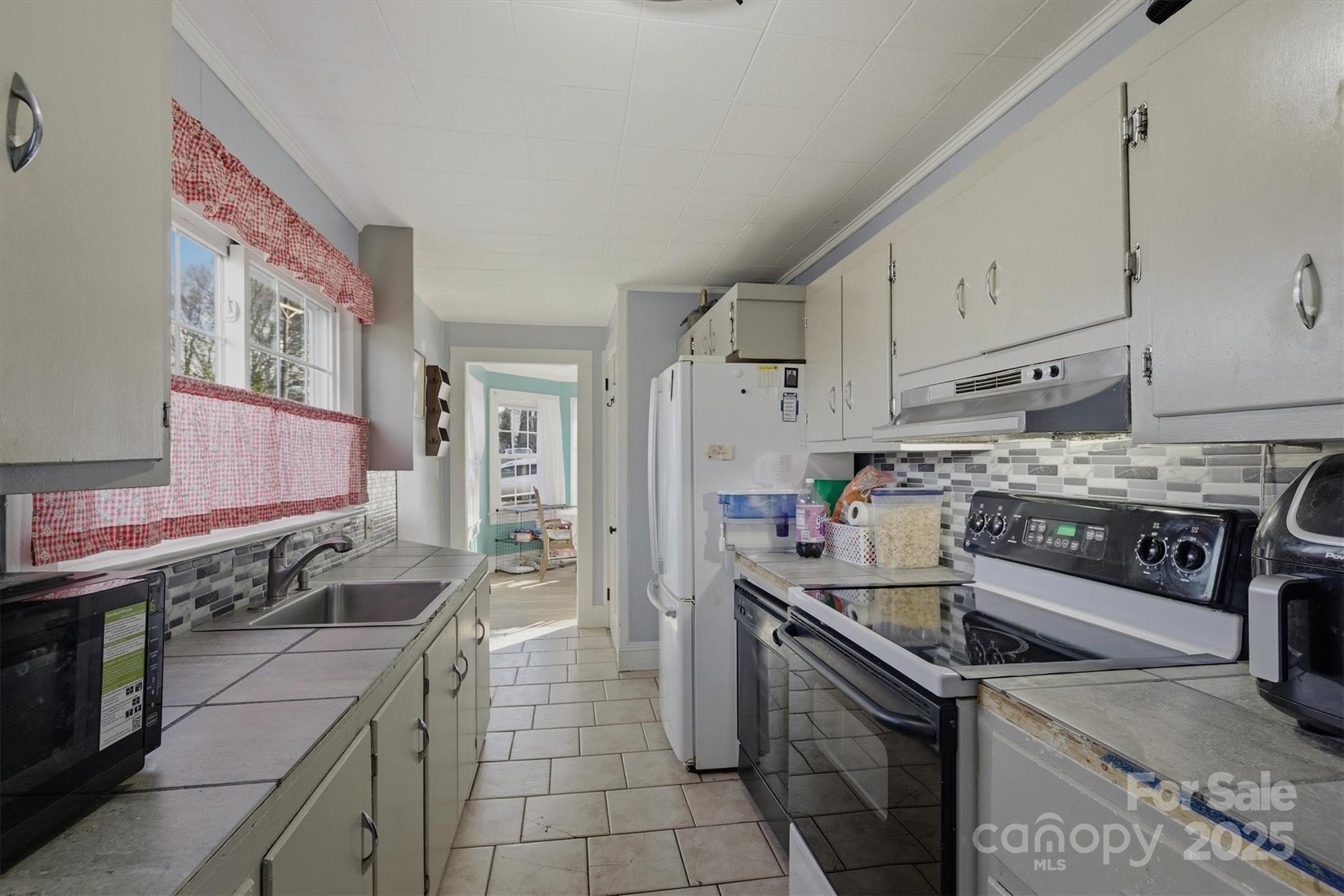 2 Stirling Street Granite Falls, NC 28630 - Photo 12 of 31 a kitchen with a stove sink and cabinets