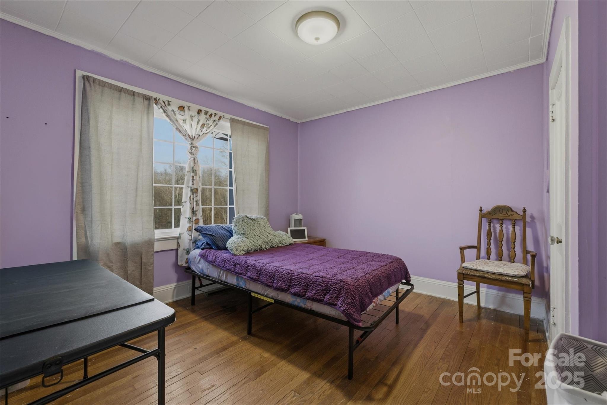2 Stirling Street Granite Falls, NC 28630 - Photo 15 of 31 a bedroom with a bed and a bookshelf with wooden floor