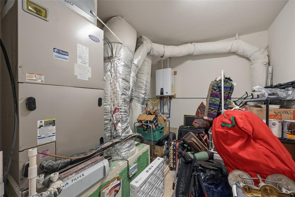 3105 Pastor Street Dallas, TX 75212 - Photo 12 of 28 Walk in Mechanical room with heating unit and tankless water heater and storage space. (encapsulated)