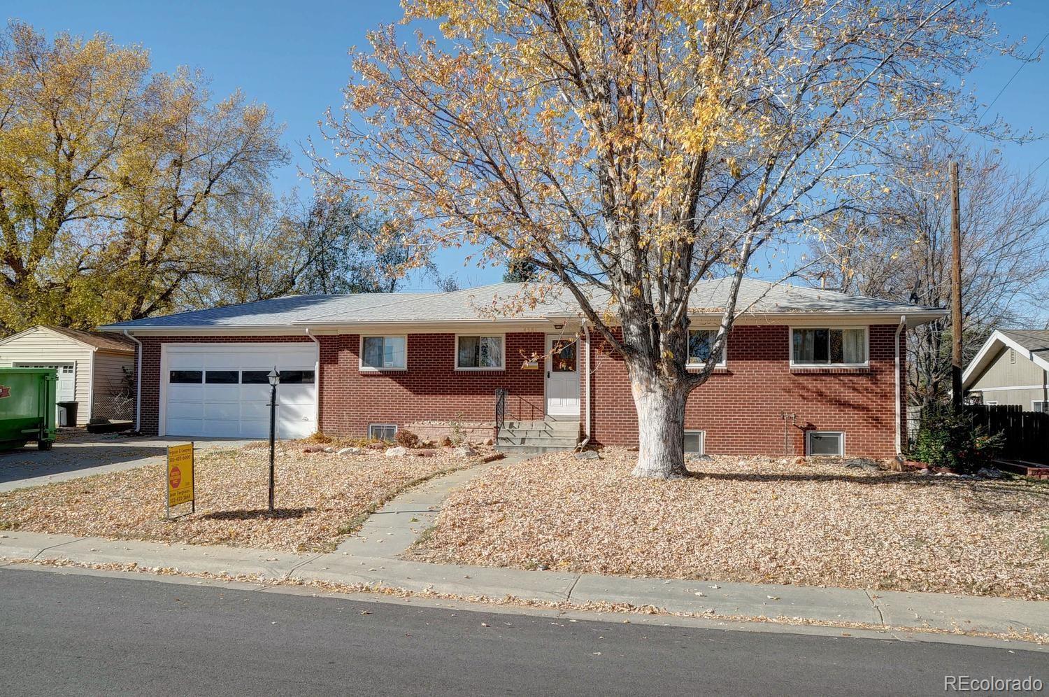 4581 Reed Street Wheat Ridge, CO 80033 - Photo 1 of 29 a front view of a house with a yard covered in snow
