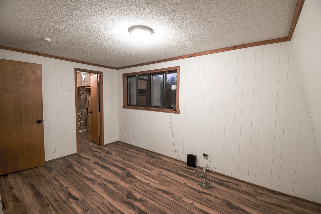 48 Glen Torr Mineral Bluff, GA 30559 - Photo 11 of 25 an empty room with wooden floor and windows