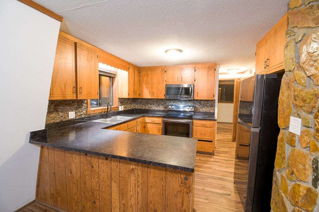 48 Glen Torr Mineral Bluff, GA 30559 - Photo 15 of 25 a kitchen with stainless steel appliances granite countertop a refrigerator a sink and a stove