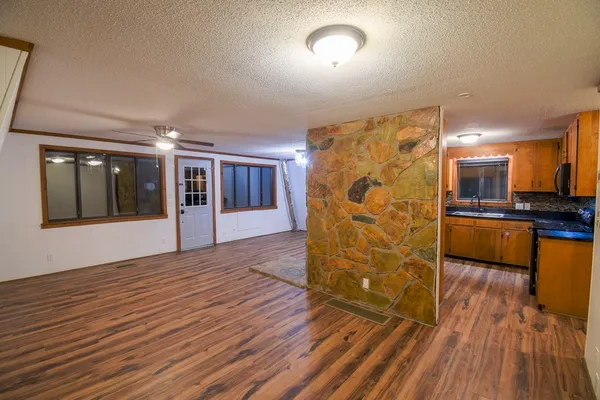 a view of a kitchen with wooden floor and a kitchen