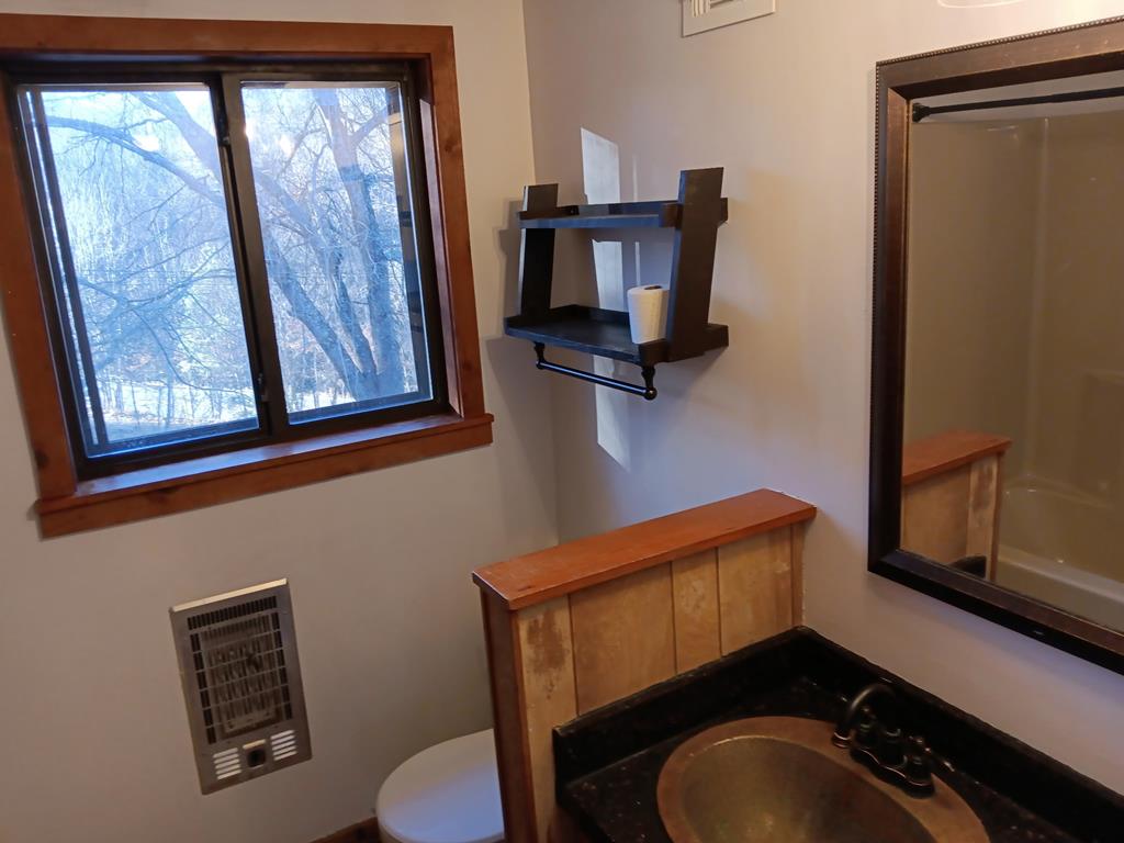 48 Glen Torr Mineral Bluff, GA 30559 - Photo 23 of 25 a bathroom with a toilet mirror and vanity