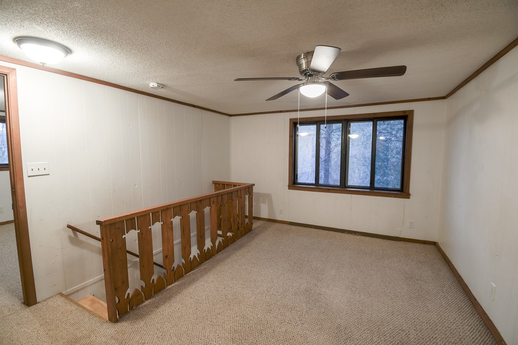 48 Glen Torr Mineral Bluff, GA 30559 - Photo 9 of 25 an empty room with windows and fan