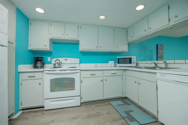 a kitchen with cabinets appliances and a sink