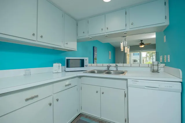 a kitchen with a sink and cabinets