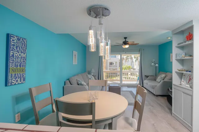 a view of a dining room with furniture wooden floor and a chandelier