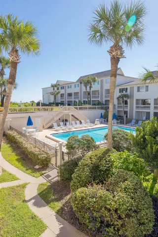 a swimming pool with outdoor seating and yard