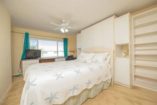 a bedroom with a large bed and a large window