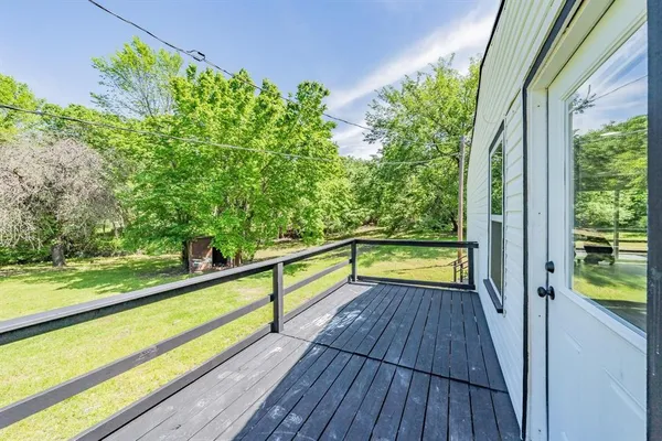 a view of a balcony with wooden floor