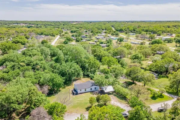 an aerial view of a houses with a yard