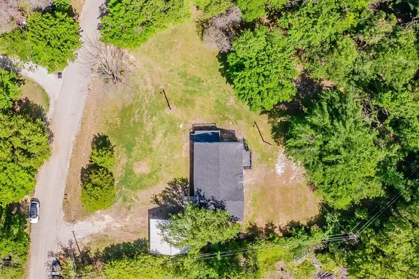 an aerial view of a house with a yard