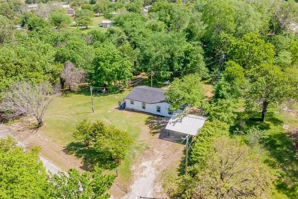 an aerial view of a house with a yard basket ball court and outdoor seating