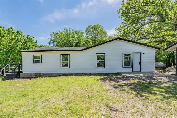 a view of a house with a yard