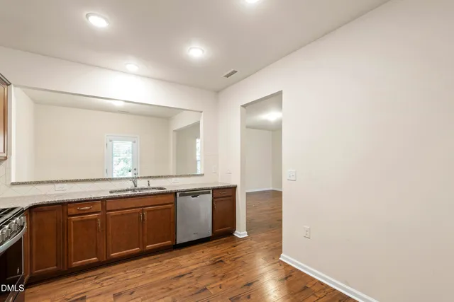 a view of a kitchen counter space with wooden floor
