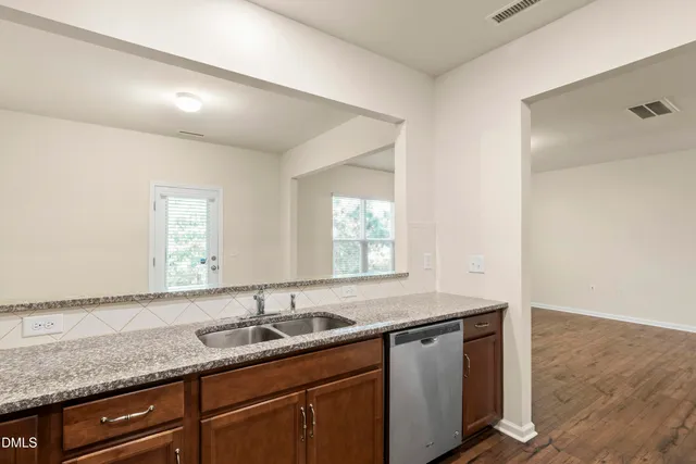 a kitchen with granite countertop a sink and a window