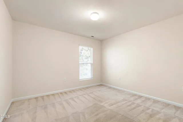a view of a house with a yard and potted plants