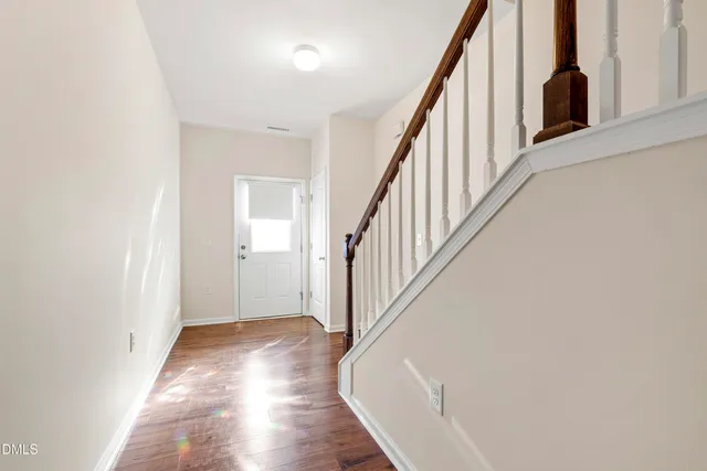 a view of an entryway with wooden floor